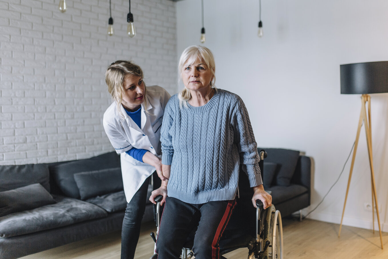 seniorr_woman-assisted-by-health-worker-out-of-wheelchair The Benefits of Enhanced Assisted Living for Aging Adults